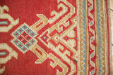 Vintage Oushak runner: cherry red, ivory, sky blue hook and latch motif, striped border.