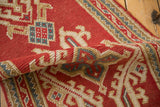 Vintage Oushak runner pile texture, cherry red field with angular blue and ivory motifs.