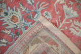 A folded corner on the distressed Anatolian rug reveals its hand-knotted back and restored side.