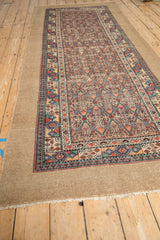 Angled view of an antique Persian Serab runner highlighting the wide, plain camel hair border.