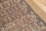 The intact wide camel-toned border and hand-knotted pile of an antique Serab runner.