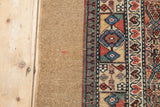 Wide plain camel hair band and intact side cord of a hand-knotted antique Serab rug.