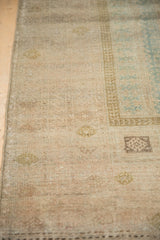 Distressed vintage Belouch rug displaying even wear across knot heads, with faded platinum and dusty teal tones.