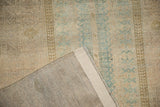 Hand-knotted foundation, intact side selvage, and distressed dusty teal pattern of vintage Belouch rug.