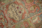 Detail of the central medallion's woven inscription on a distressed Baktiari rug.