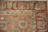 Uniquely drawn arabesque and blossom border on a distressed vintage Persian rug.