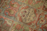 Close-up of the central medallion with woven inscription on a distressed Persian Baktiari rug.