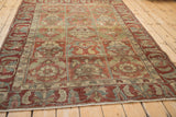 High angle view of a vintage Baktiari rug's panel design and distressed, time-softened texture.