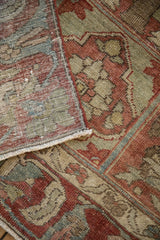 The hand-knotted foundation and distressed pile visible on the folded corner of a vintage Bakhtiari rug.