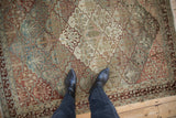 A view of the distressed, low-pile surface of a Baktiari rug with trellis lattice panels.