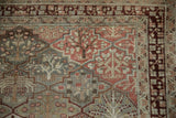 Detail of a Baktiari rug's distressed lattice panels with tree of life motifs.