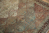 Detail view of the distressed, low pile on a Baktiari rug with slate blue and red lattice panels.