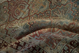 Time-softened texture of a vintage Baktiari rug in slate blue and dusty raspberry tones.