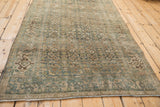 Distressed vintage Bijar rug displaying Herati motif, Turtle Samovar border, and heavy abrashes.