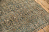 Distressed vintage Bijar rug, showing heavy abrashes on dusty blue Herati and border motifs.