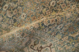 Textured pile of a distressed Bijar rug, showcasing heavy abrashes and dusty blue Herati designs.