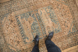 Distressed pictorial Qashqai rug with lion and tree-of-life motifs, ivory and dusty blue.