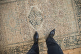 Close-up showing the distressed, low-pile texture and geometric motifs of a vintage Karaja rug.