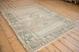 Vintage Karaja rug with even wear, showing its geometric pattern in sand and dusty teal.