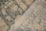 A close view of the vintage Karaja rug's distressed pile and its hand-knotted foundation.