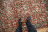 A view highlighting the distressed low pile and geometric pattern of a vintage Karaja rug.