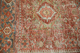 Distressed pile of a vintage Karaja rug showing wear across the foundation and knot heads.