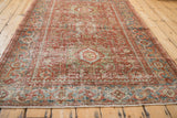 Low angle view along the worn, hand-knotted pile of a distressed vintage Karaja rug.
