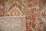Hand-knotted foundation and distressed pile of a Persian Karaja rug shown at a folded corner.