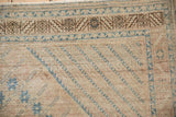 Distressed vintage Afshar rug border shows charcoal brown serrated leaf motif and dusty sapphire blue details.