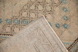 Afshar rug's hand-knotted foundation, fringe, and distressed blue starburst pile.
