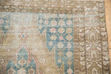Vintage Distressed Mazlaghan rug's dusty blue spandrel and lattice palmette pattern, showing knot wear.