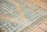 Distressed Mazlaghan rug corner, pale blue lattice, ochre quarter medallion, serrated contour.
