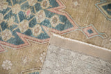 Distressed pile of vintage Mazlaghan rug, with foundation showing through and hand-knotted reverse.