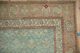 Vintage distressed Karabagh runner corner, dusty peach border with serpent motif, pale blue plant field.