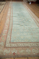 Distressed traditional Karabagh runner field with germinating plants and ruby red serpent border.