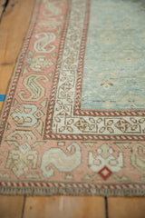 Pale peach Karabagh rug border showing serpent floral motif and distressed texture.