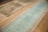 Pale peach and ivory serpent stylized floral motif on the distressed Karabagh runner border.
