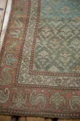 Distressed Karabagh runner detail: serpent floral border and germinating plants in turquoise, ruby red, ivory, with mostly even wear.