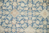 Distressed vintage Hamadan rug detail with Herati pattern, sky blue, ivory, and faint foundation.