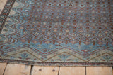 Detail of the antique Malayer's restored side cord selvage and reduced geometric border.