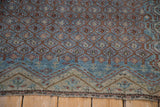 Mostly even wear to knot heads on the sapphire blue and terracotta boteh lattice of an antique Malayer rug.