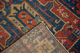 Antique Heriz rug's hand knotted foundation, with tight weave and visible colorful threads.