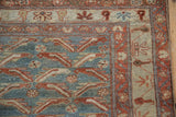 Close-up on the even wear and floral border details of a distressed Persian Malayer rug.