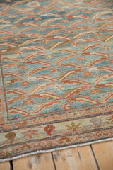 Low pile texture showing the fish design motif on a distressed vintage Malayer rug.