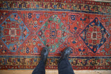 Intricate antique Heriz rug medallion detail with pinwheel motifs and gem-like colors.