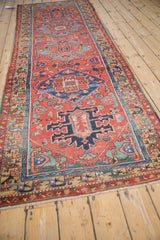 Antique Heriz runner showing gem-tone geometric motifs and serpent-like vine border.