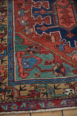 Antique Heriz runner's main border detail, showcasing brick red, indigo, and teal meandering vines.