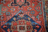 Antique Heriz runner: brick red field, sapphire and indigo blue floral motifs, exposed foundation.
