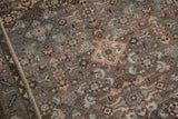 Detail of vintage Hamadan runner's geometric Herati pattern with even wear and muted tones.