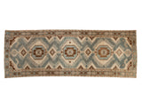 Vintage distressed Malayer runner with interconnected geometric medallions in dusty blue, brown, and ivory.